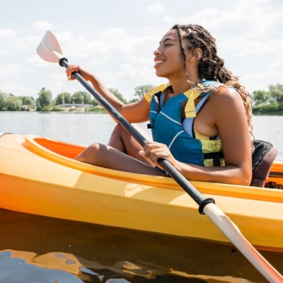 Girl kayaking on lake